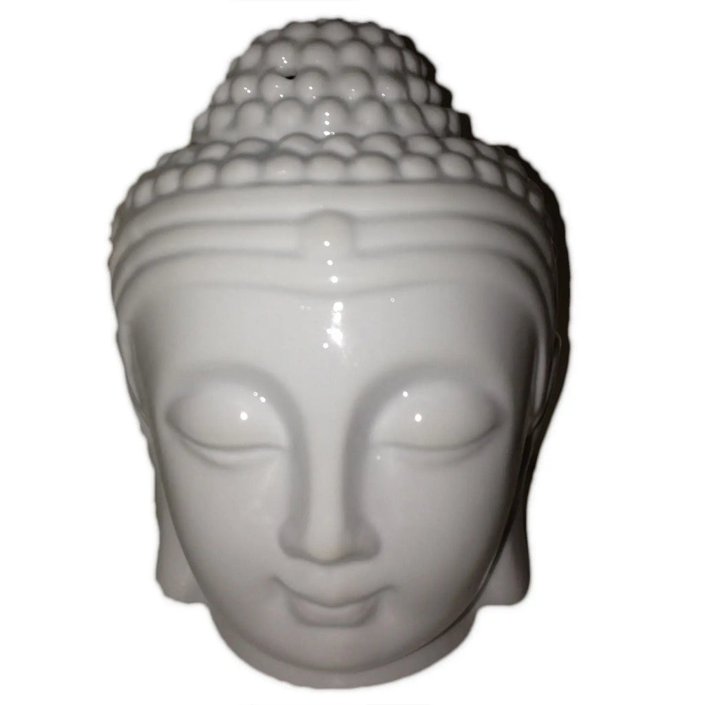 White ceramic Buddha head on a white background
